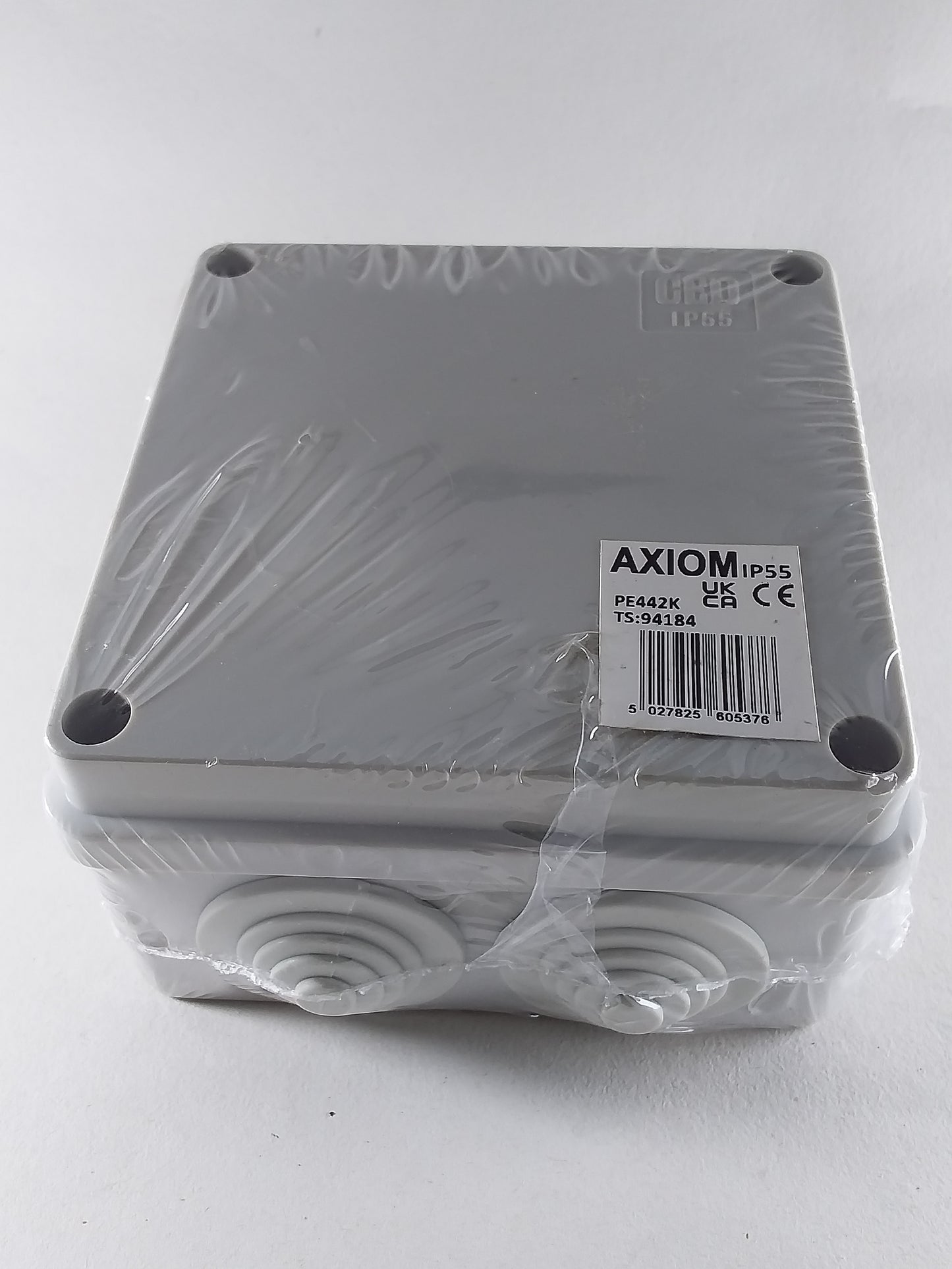 A 100mm square silver-colored enclosure box with a label indicating it is an IP56 product, placed on a white background.