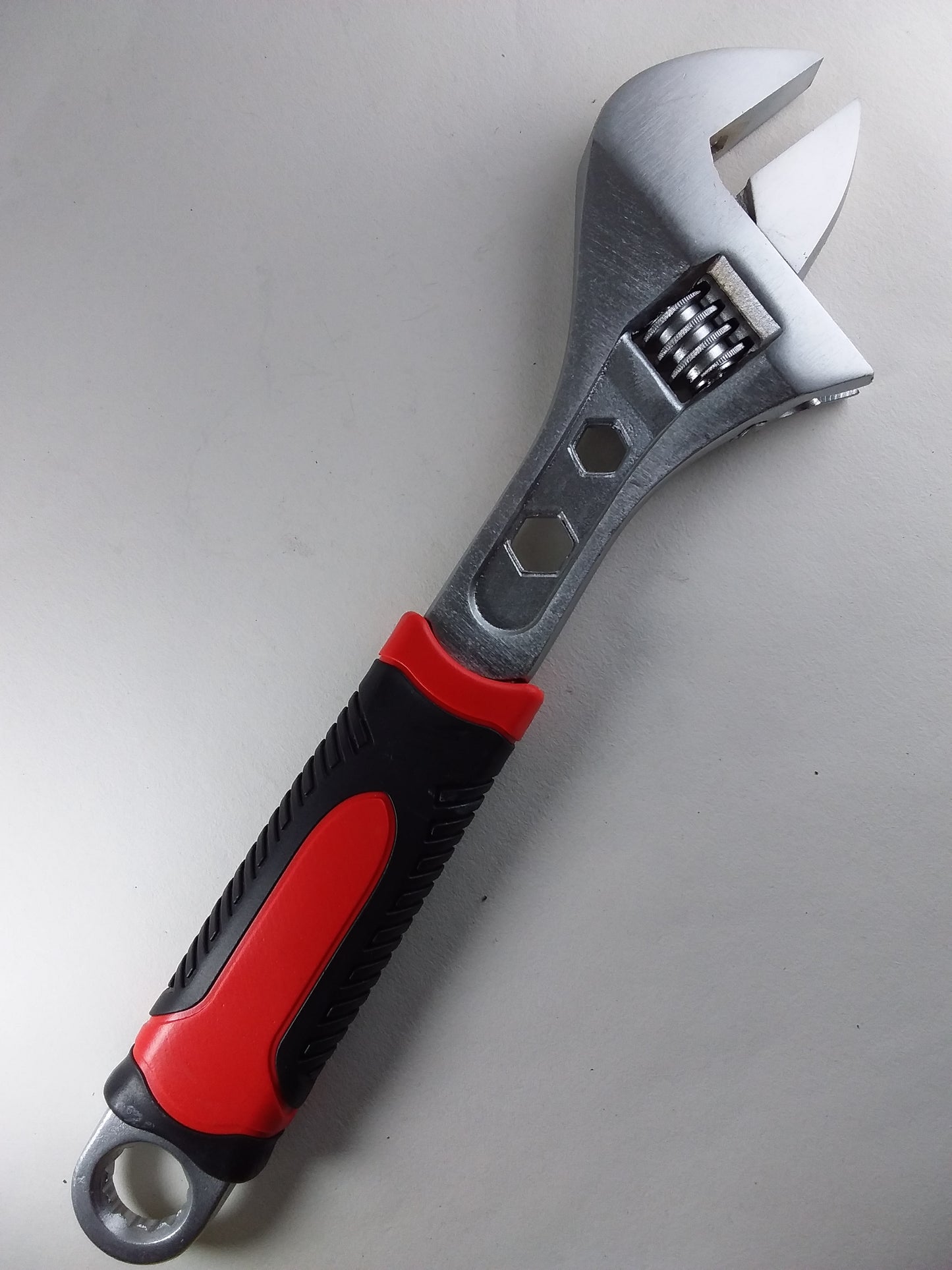 10-inch adjustable wrench with a black and red soft grip handle.