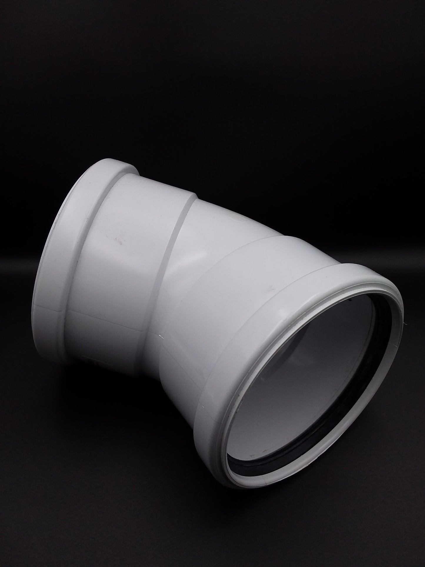 A white 110mm double socket 45deg push fit bend for plumbing.