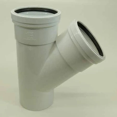 A white 110mm double socket 45deg tee plumbing fitting.