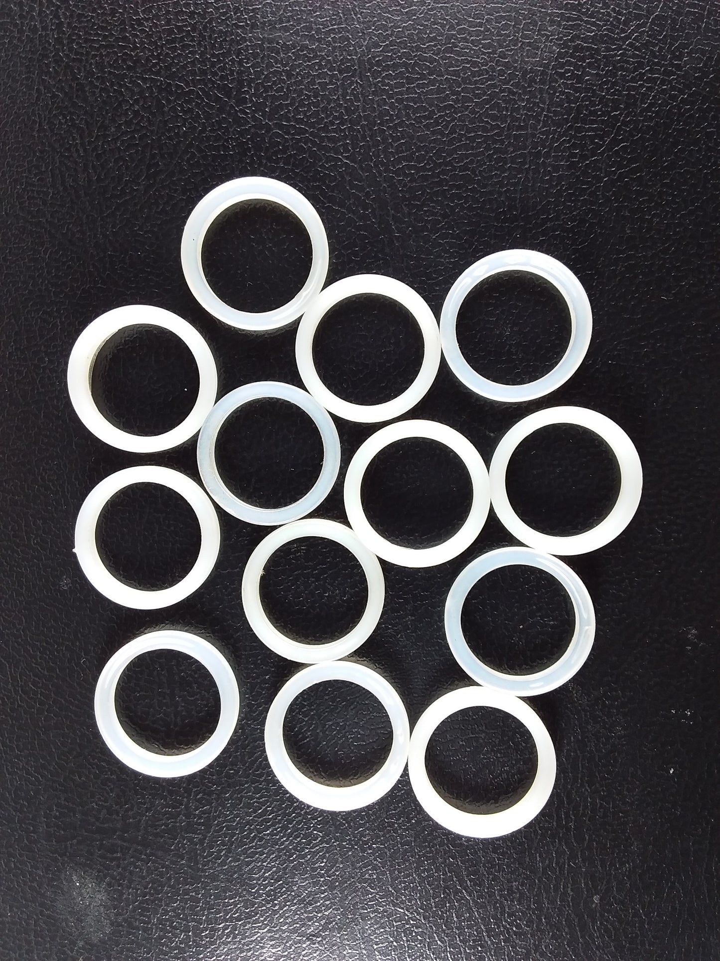 A collection of white nylon cap lining washers.