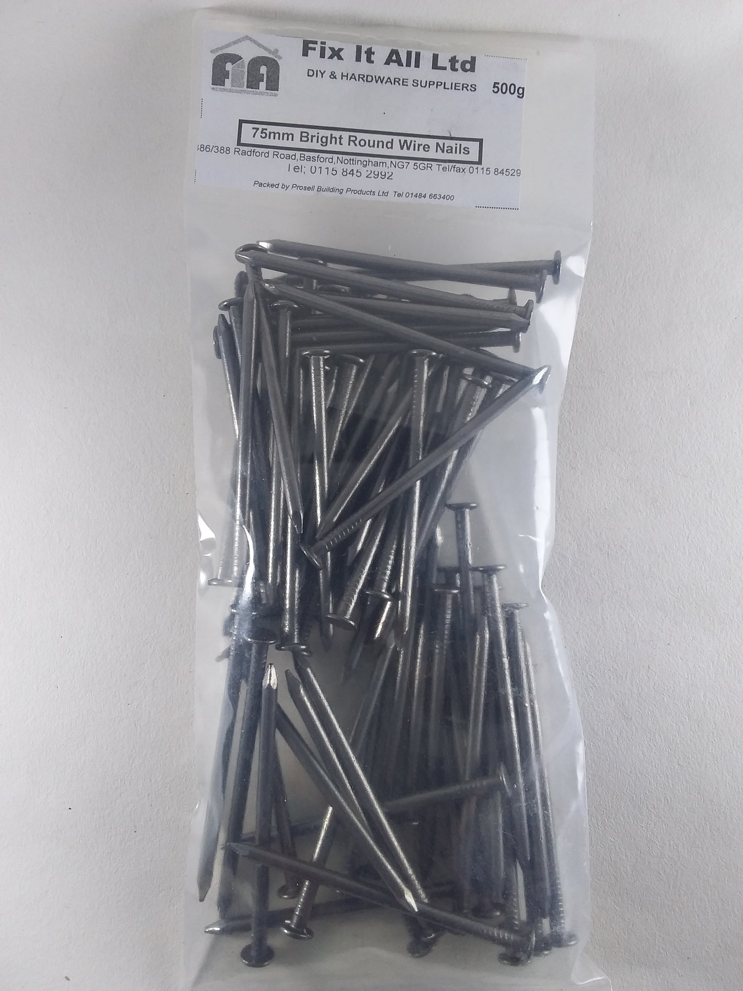 A clear plastic bag containing bright oval nails, with a label indicating the product weight and brand 'Fix it All Ltd'.