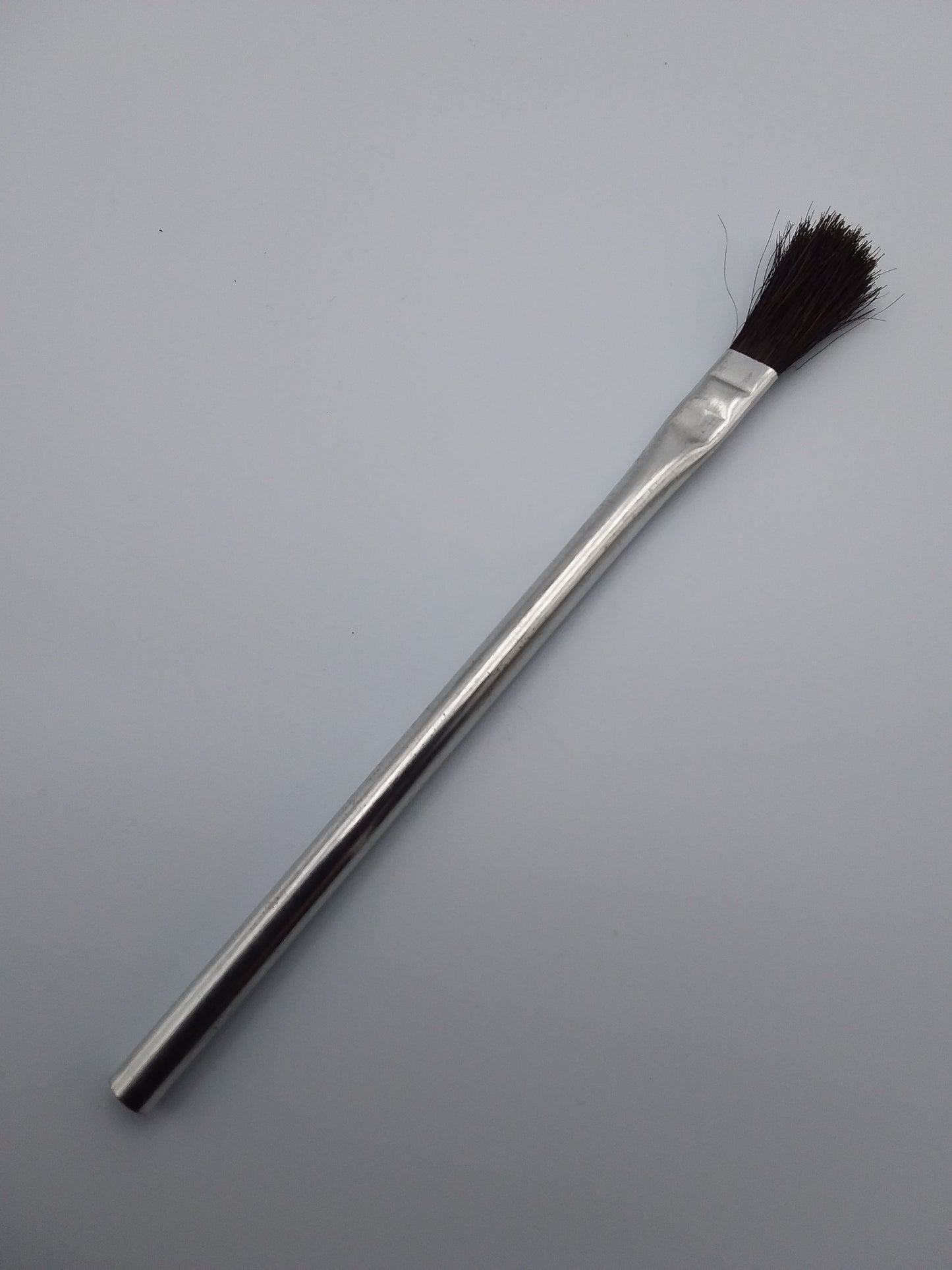 12mm flux brush with a metal handle and black bristles.