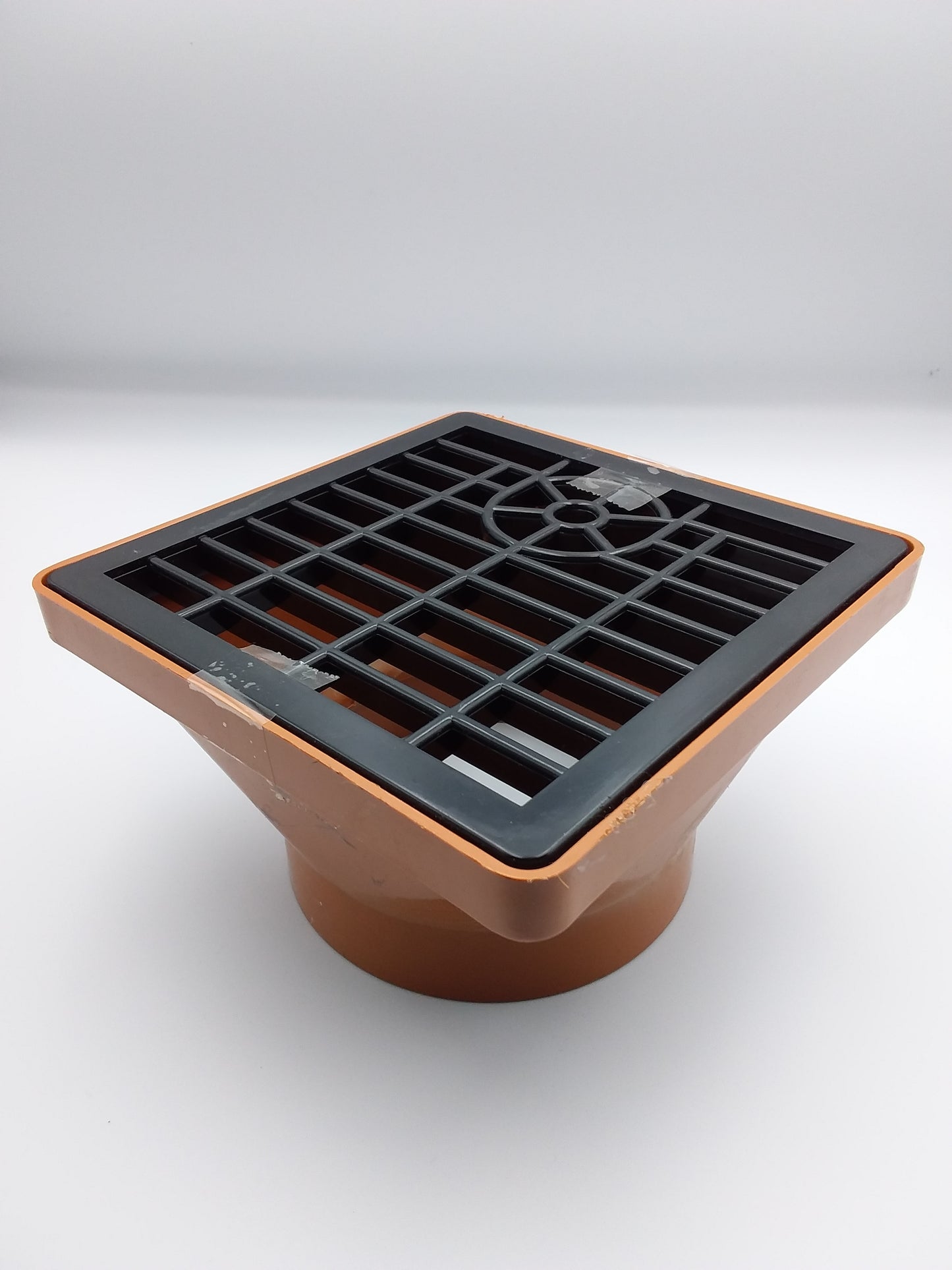110mm brown square-shaped underground hopper with a grid-like pattern on the top.