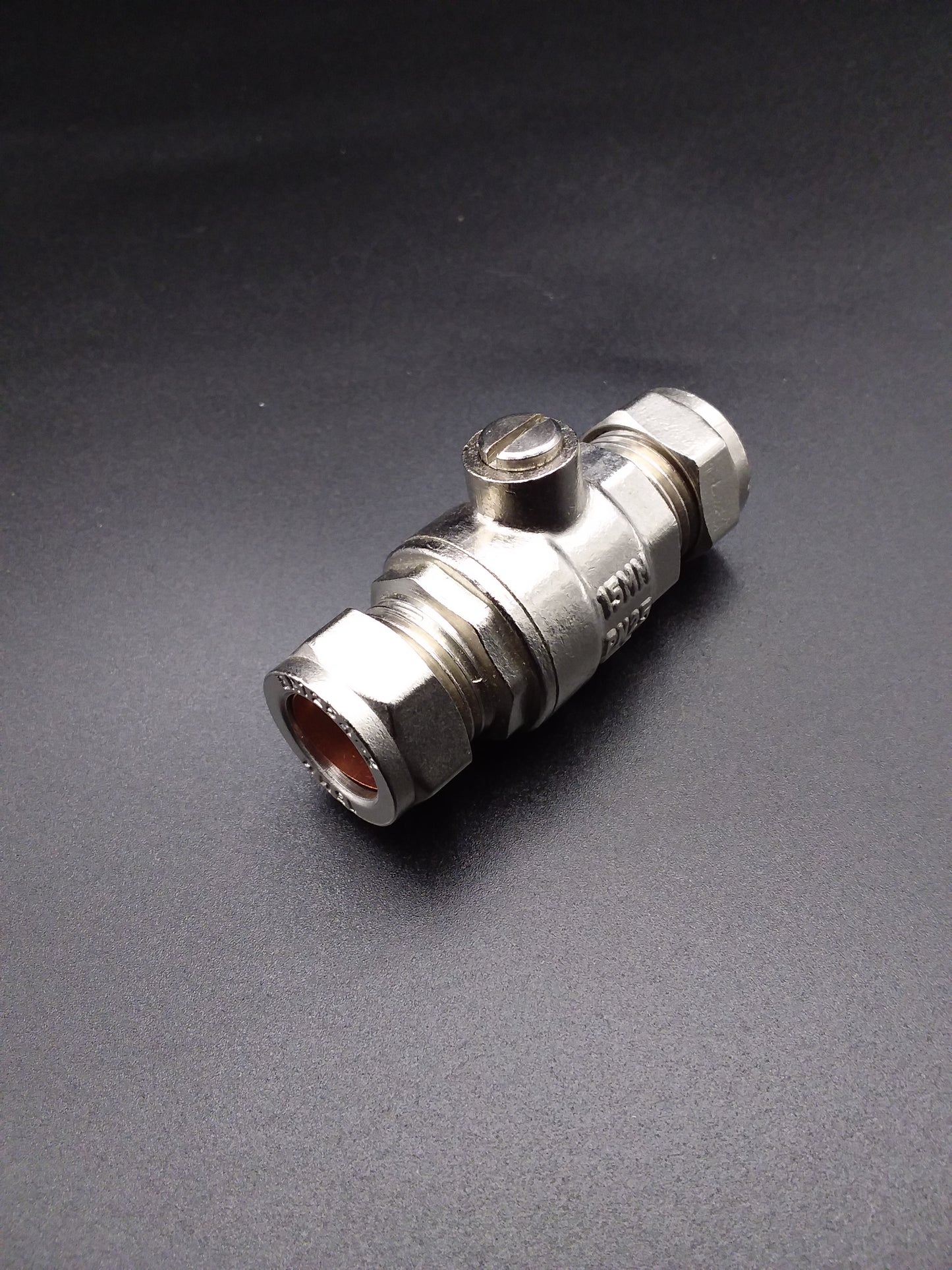 A 15mm chrome full bore isolating valve with a dark background.