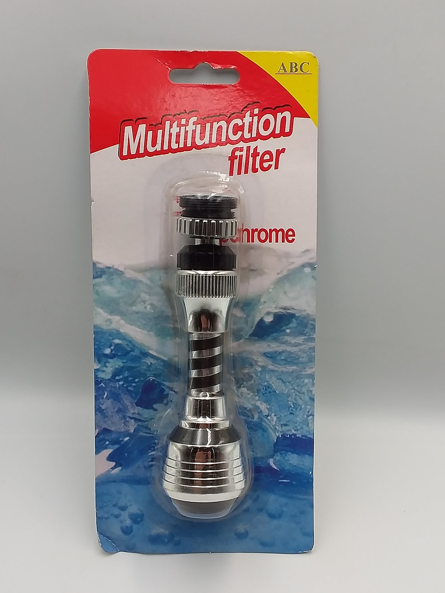A chrome multifunction tap filter is packaged in a blister pack with a red and white card. The filter is designed to attach to a faucet, and the card indicates it is 'Multifunction'.