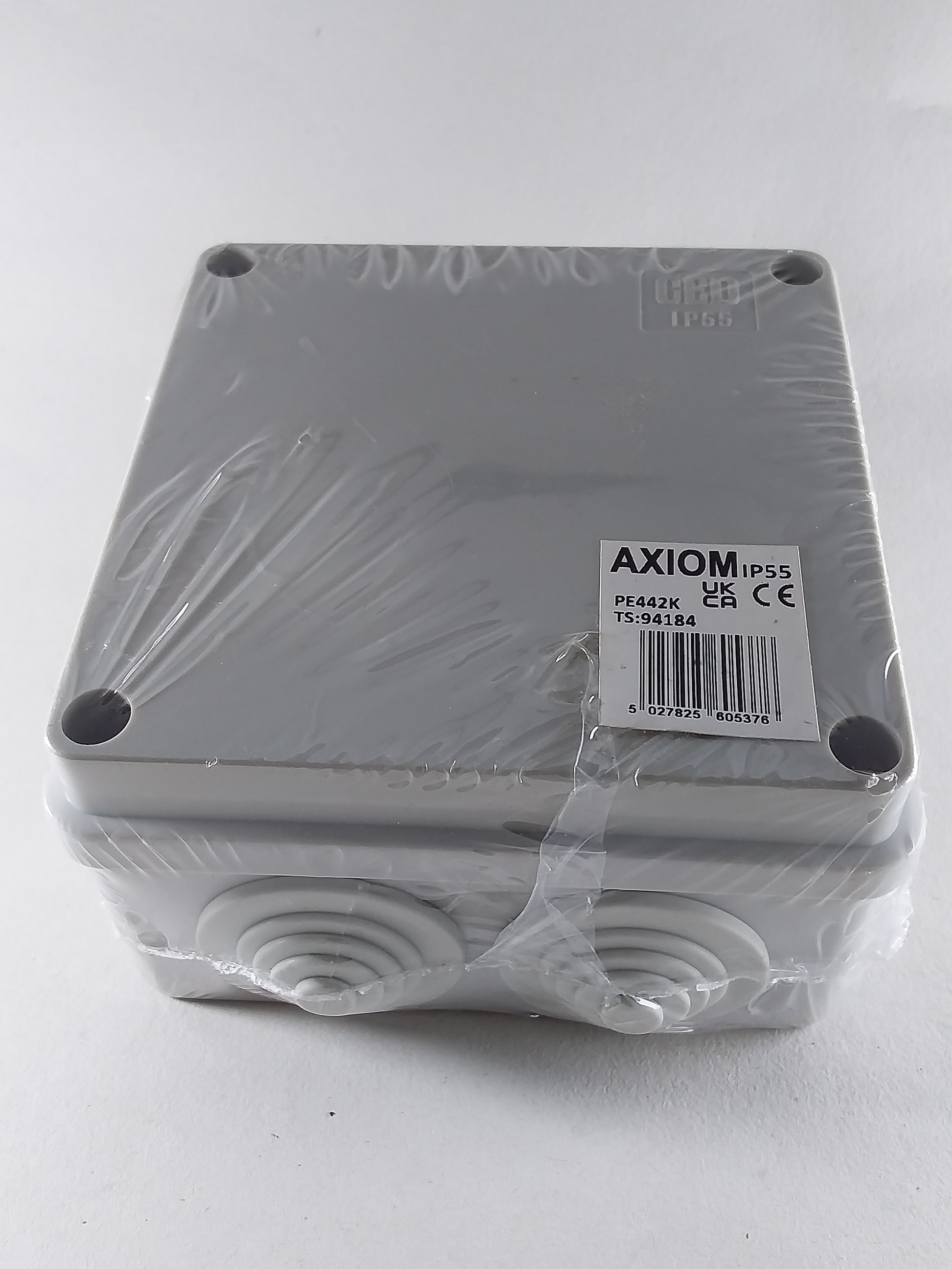 A 100mm square silver-colored enclosure box with a label indicating it is an IP56 product, placed on a white background.