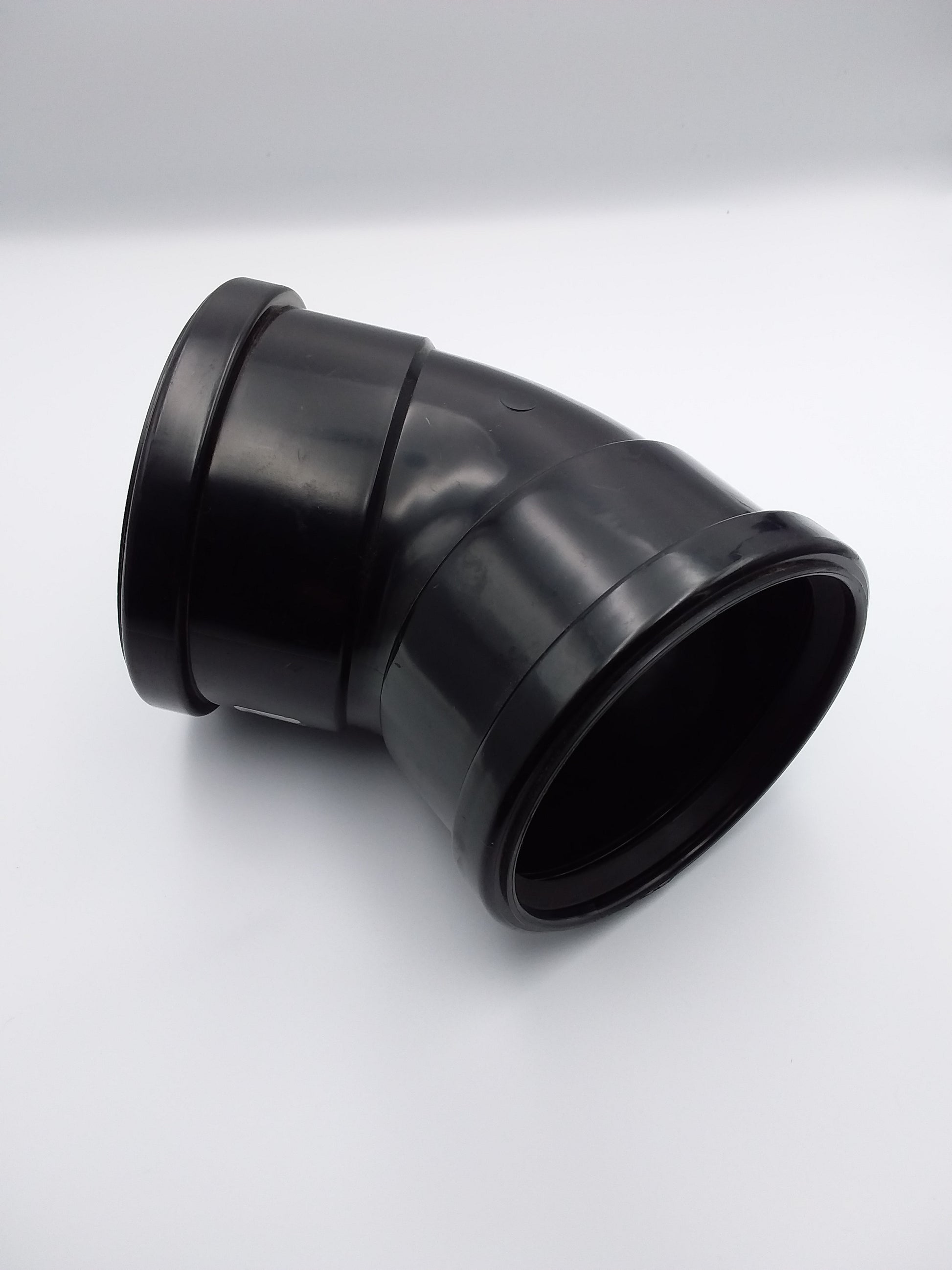 A black double socket push fit 45-degree bend plumbing fitting.