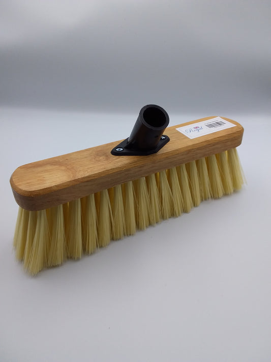 A 11 inch PVC broom head with soft bristles and a wooden block attached for mounting to a handle.