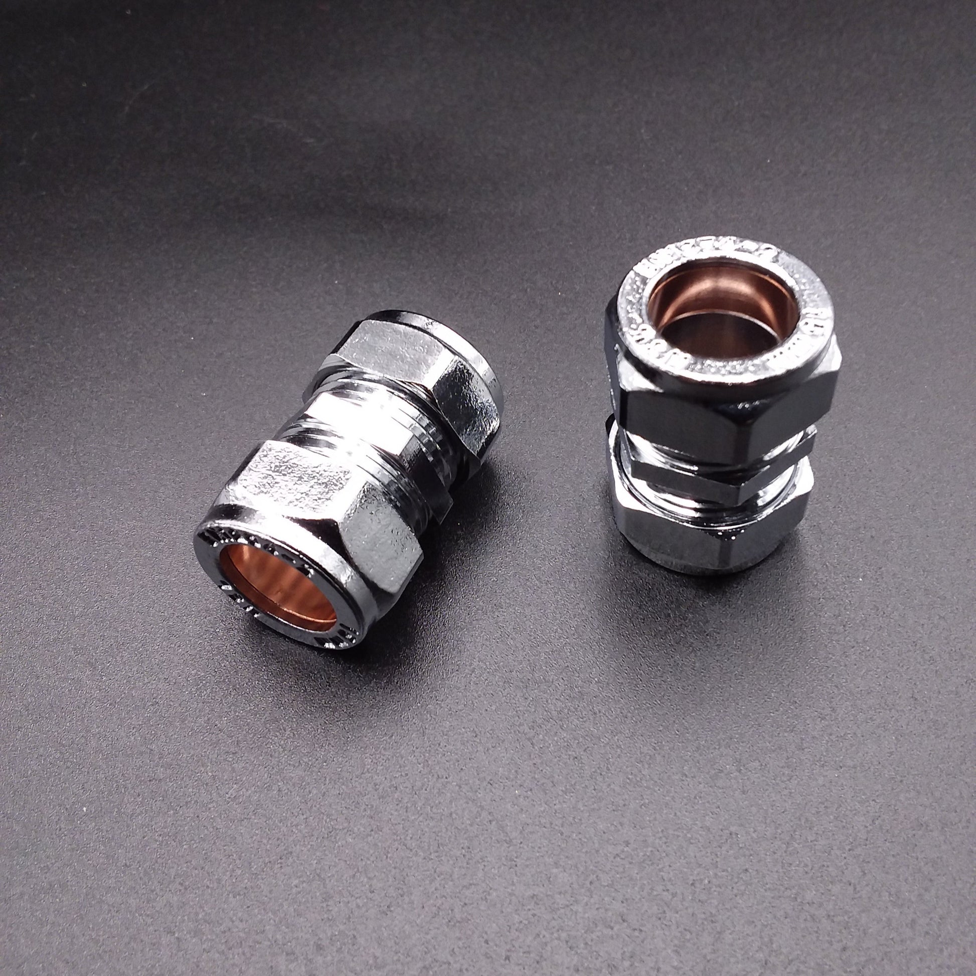 15mm chrome-plated pipe coupling typically used for compression fittings in plumbing.