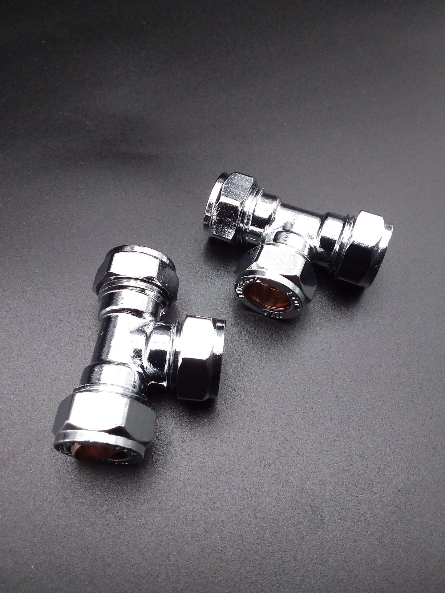 15mm chrome-plated compression tee typically used as plumbing fittings.