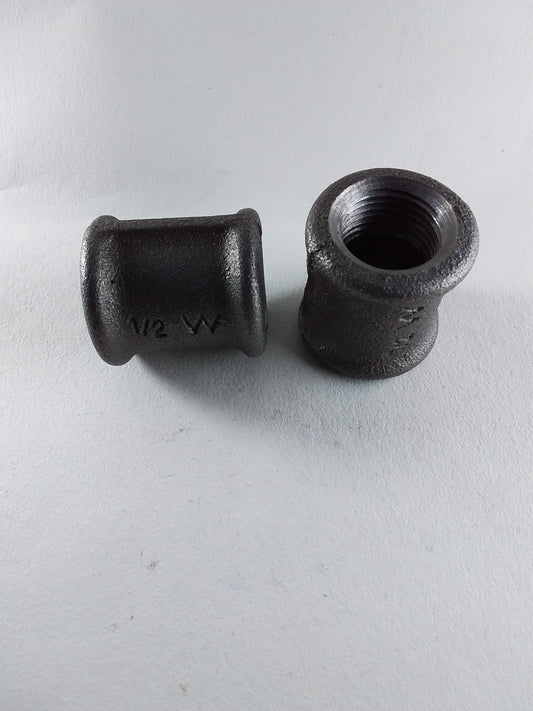 Two black iron sockets, one with threaded end visible, the other showing the interior cylindrical shape.