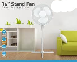 A white 16-inch stand fan with oscillating function, featuring a modern design and a stable base, placed in a room setting with a living room setup in the background.
