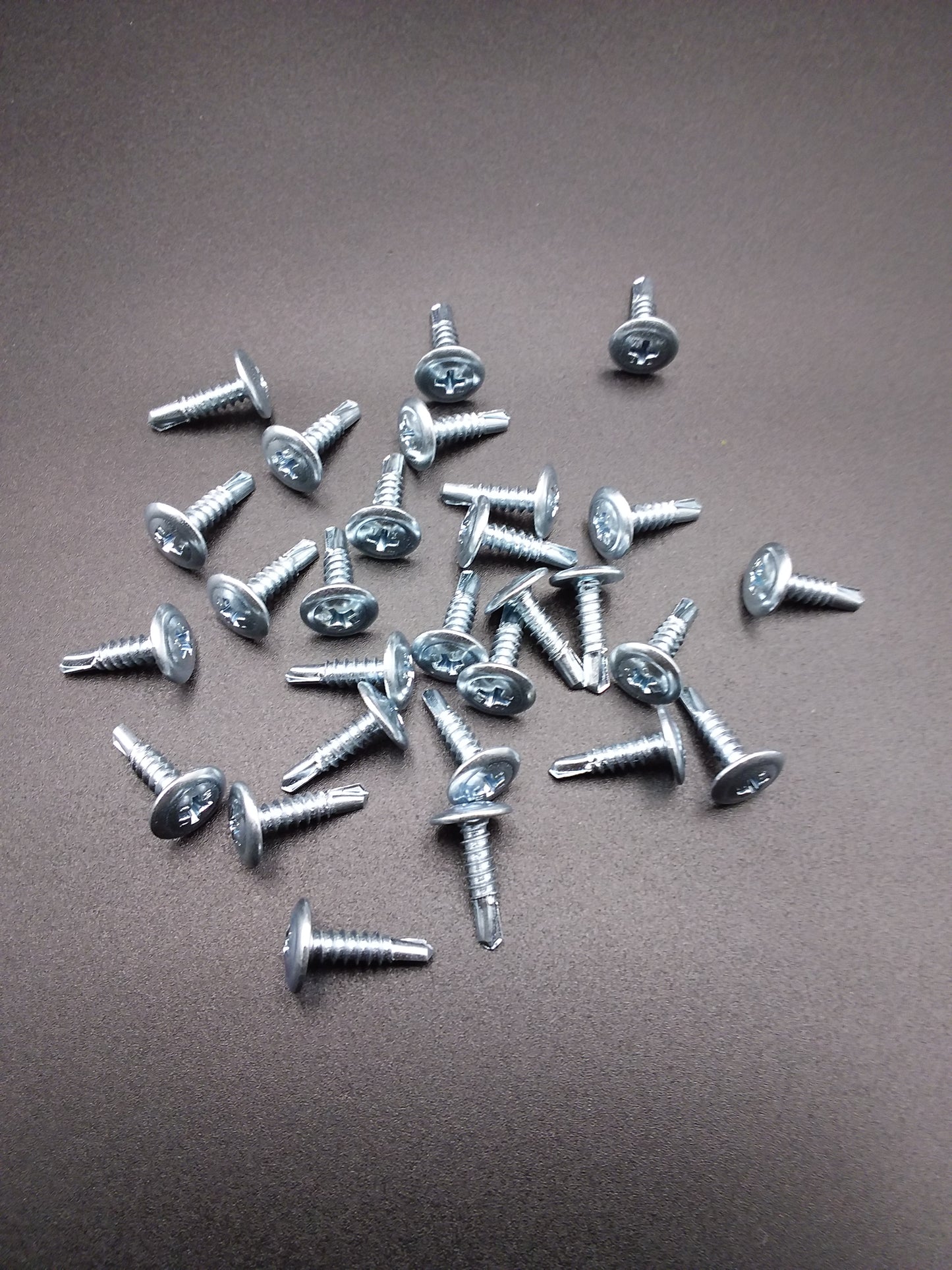 16mm metal self drilling screws with a Phillips head, displayed on a plain background.