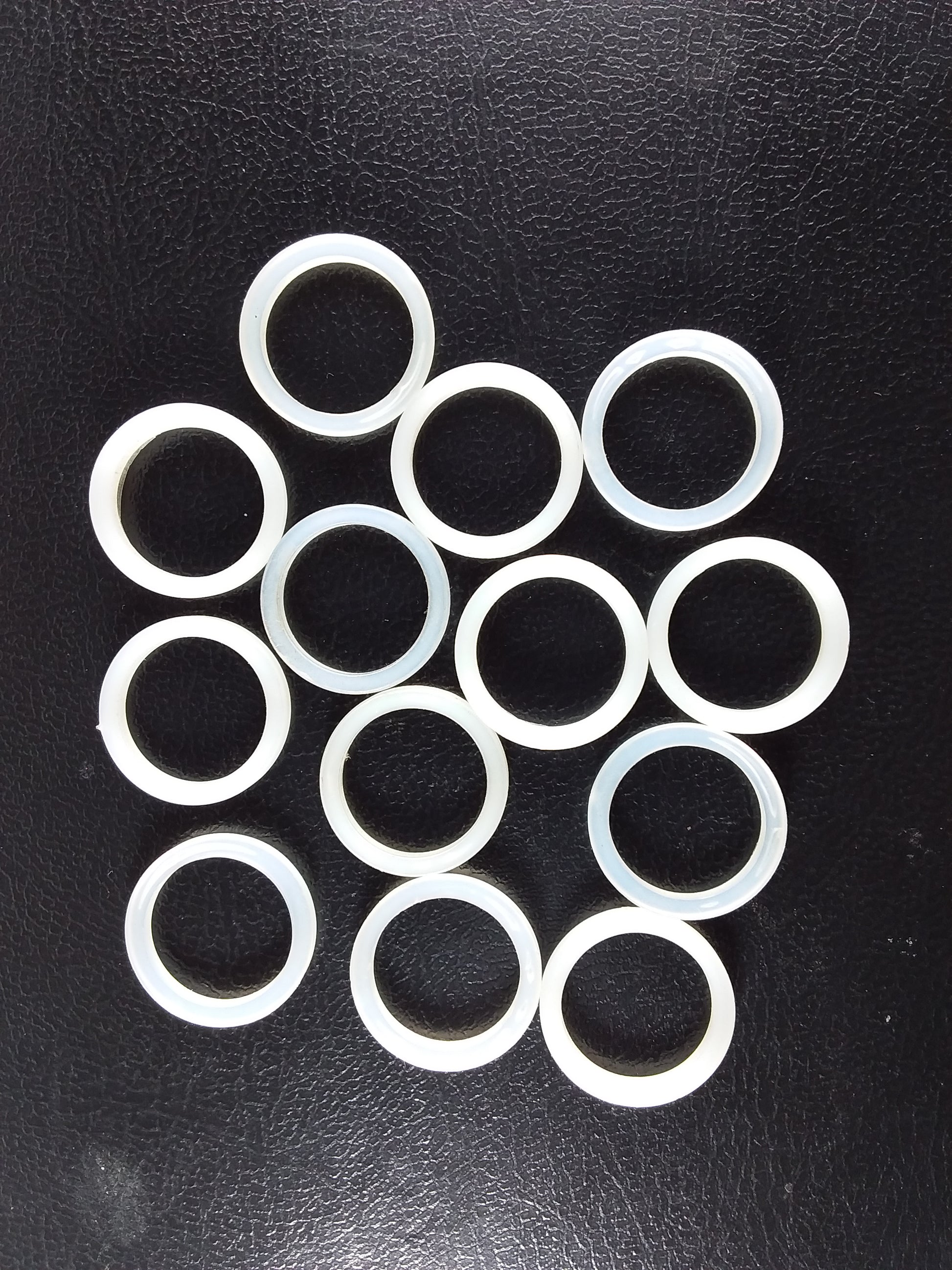 A collection of white nylon cap lining washers.