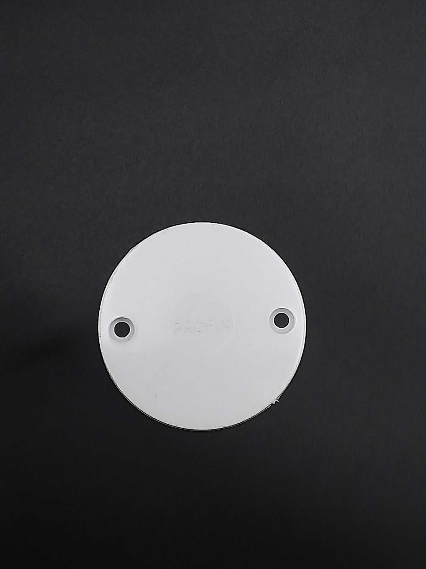 White conduit box lid with two mounting holes, viewed from the top.