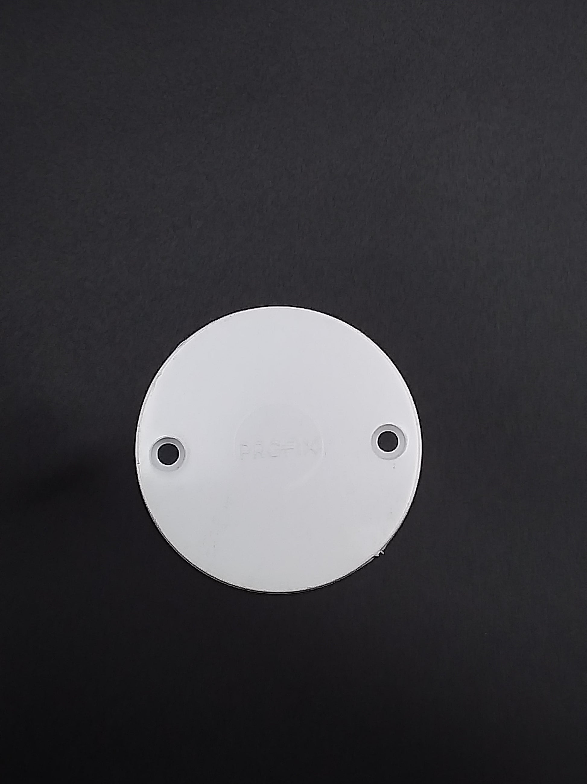 White conduit box lid with two mounting holes, viewed from the top.
