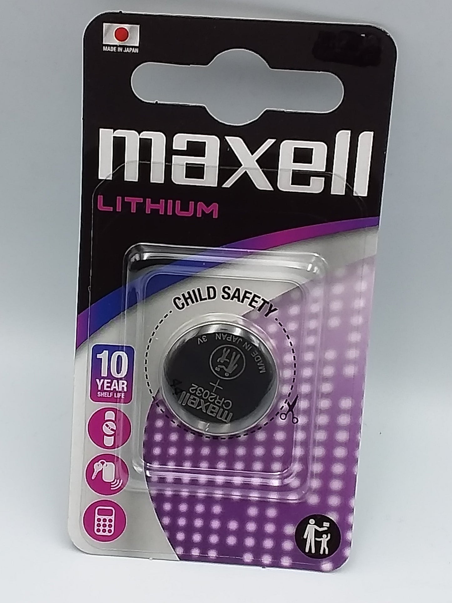 A Maxell Lithium CR2430 button cell battery packaged in a blister pack with child safety features highlighted.
