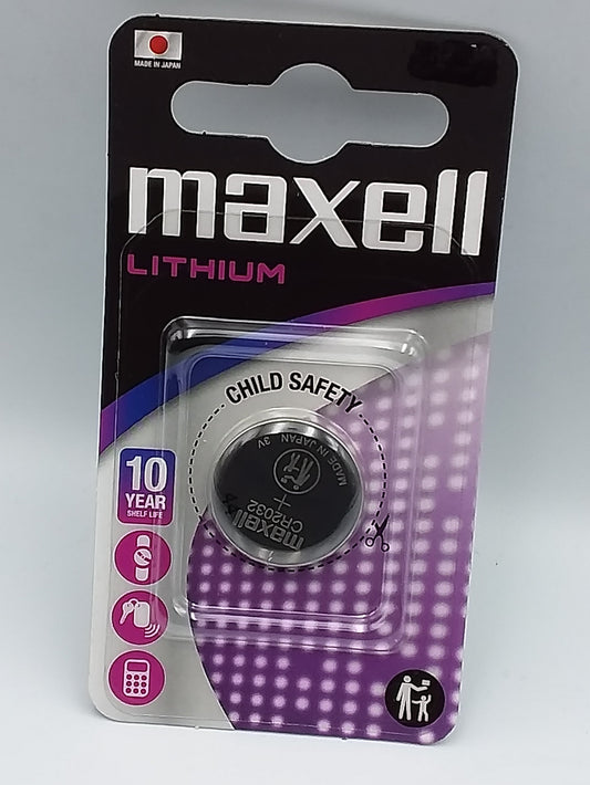 A Maxell Lithium CR2430 button cell battery packaged in a blister pack with child safety features highlighted.