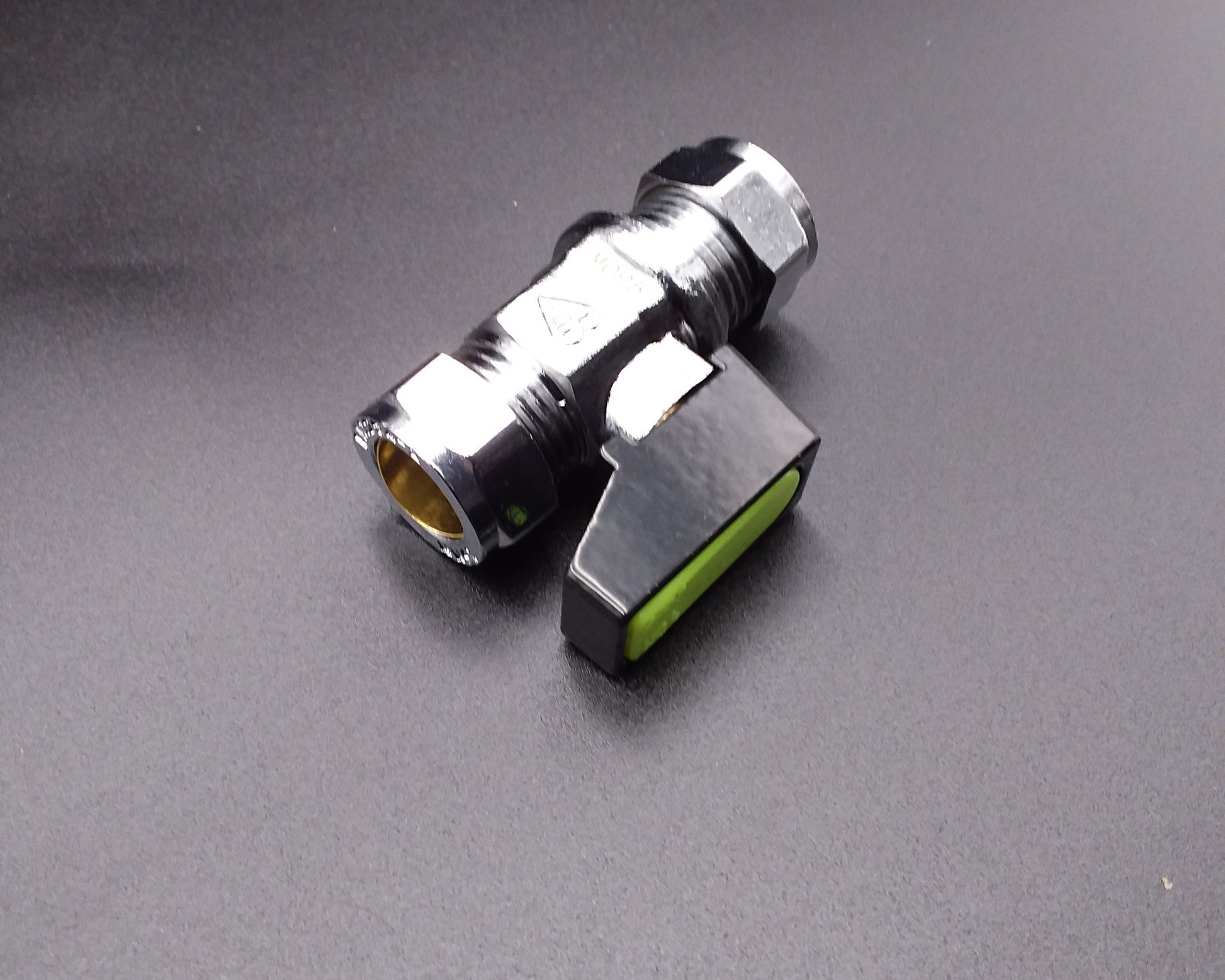 Chrome gas valve with a black handle, viewed from an angle against a plain background.