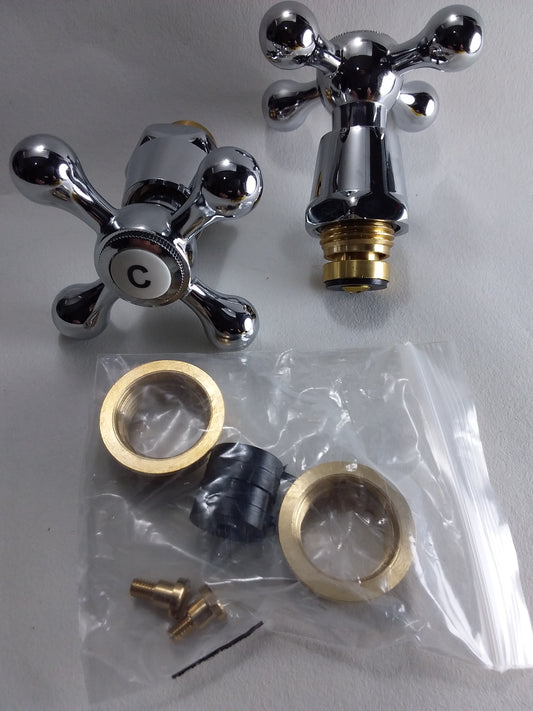 A cross head conversion kit for plumbing, consisting of two chrome faucets and associated installation parts laid out on a white background.