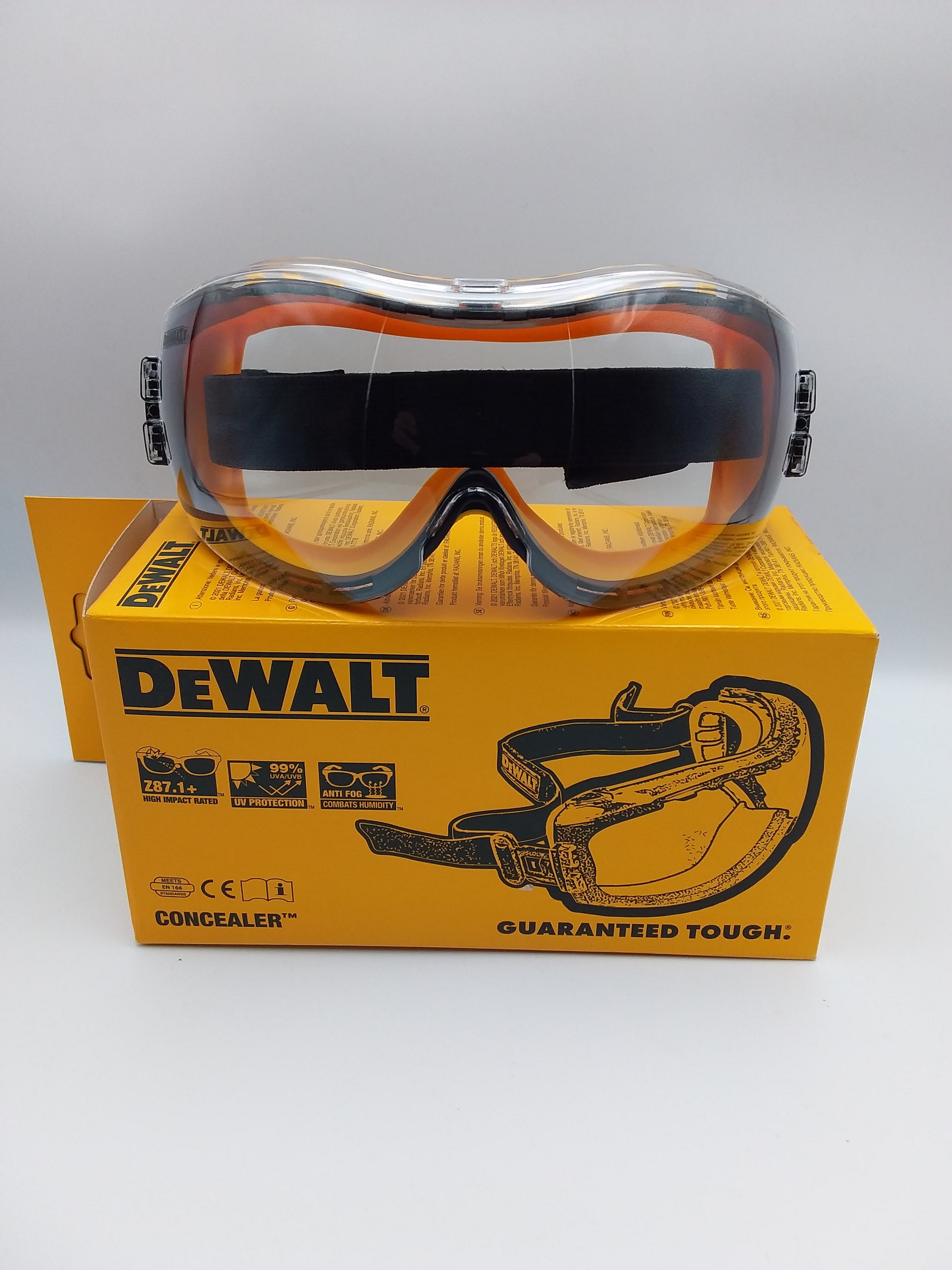 Dewalt safety goggles with orange frameless lenses, displayed in front of its packaging box with the Dewalt logo.