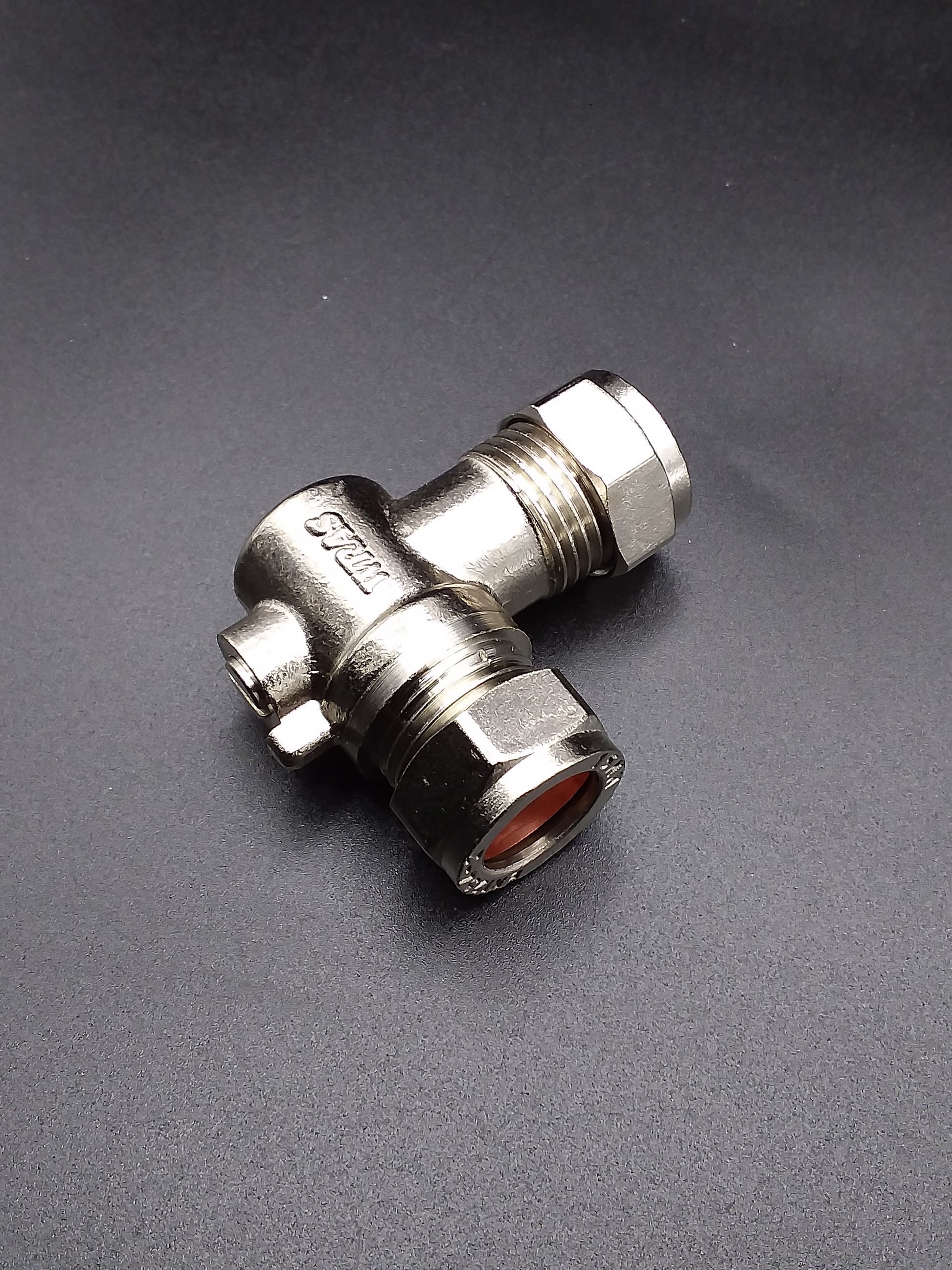 A silver-colored 15mm elbow isolating valve with threaded connections and a hand wheel for turning the valve on and off.