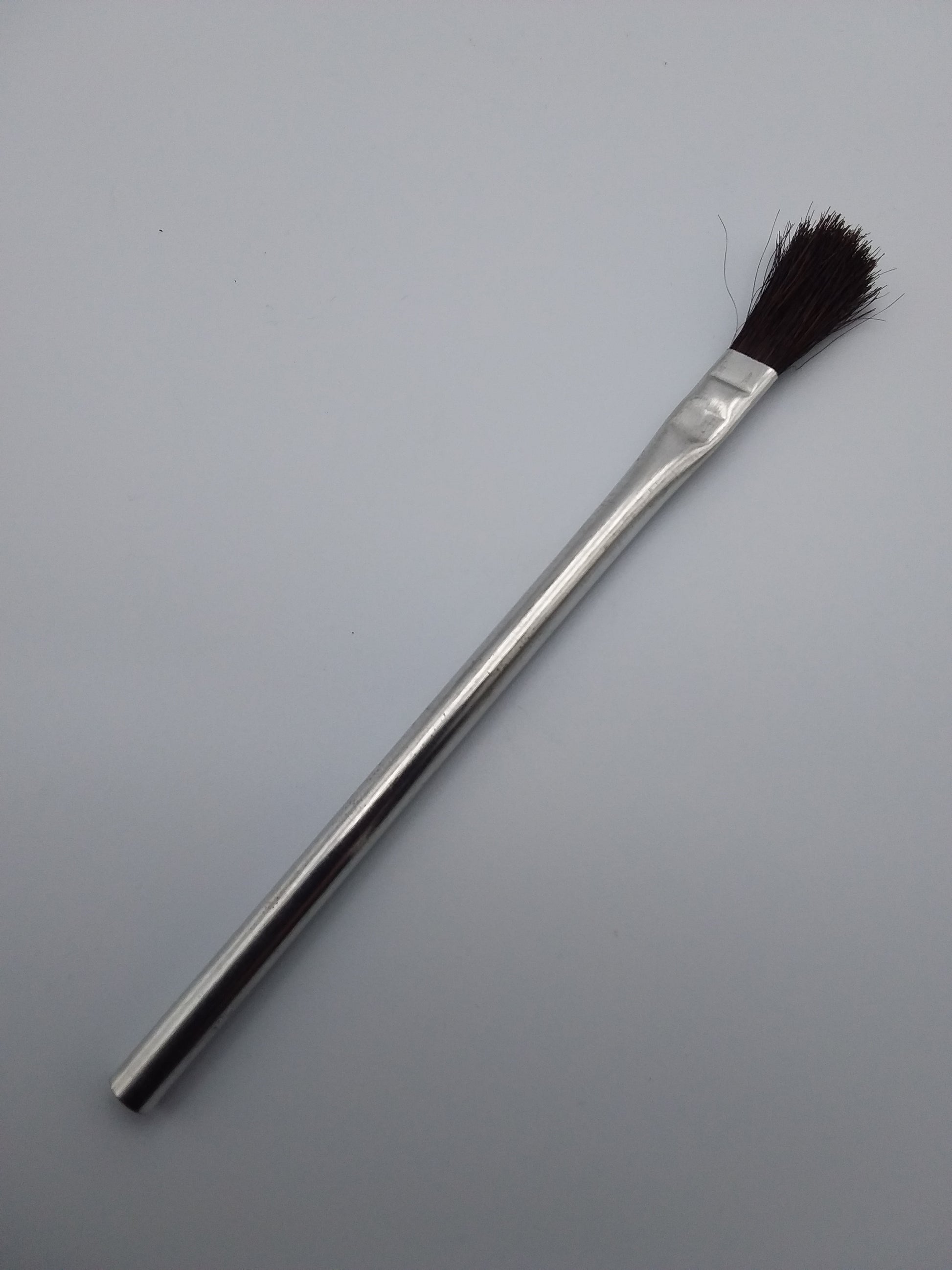12mm flux brush with a metal handle and black bristles.