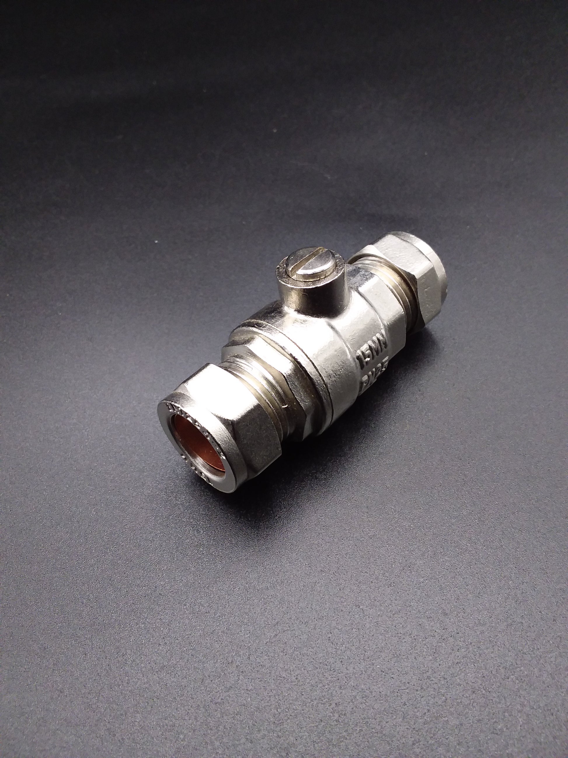 A 15mm chrome full bore isolating valve with a dark background.