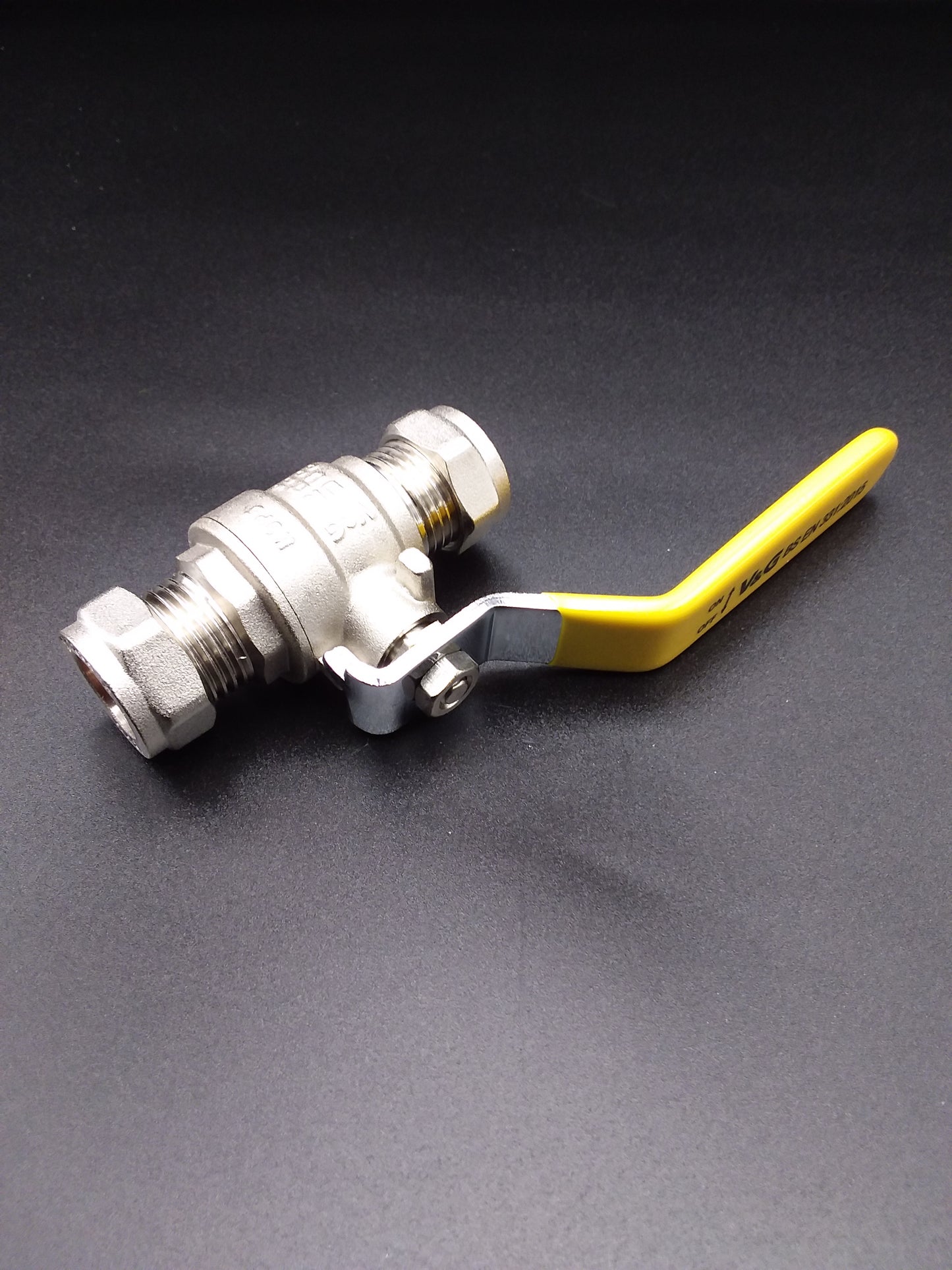 A 28mm lever ball valve with a yellow handle, primarily metallic in color, possibly silver or gray, with a black background.