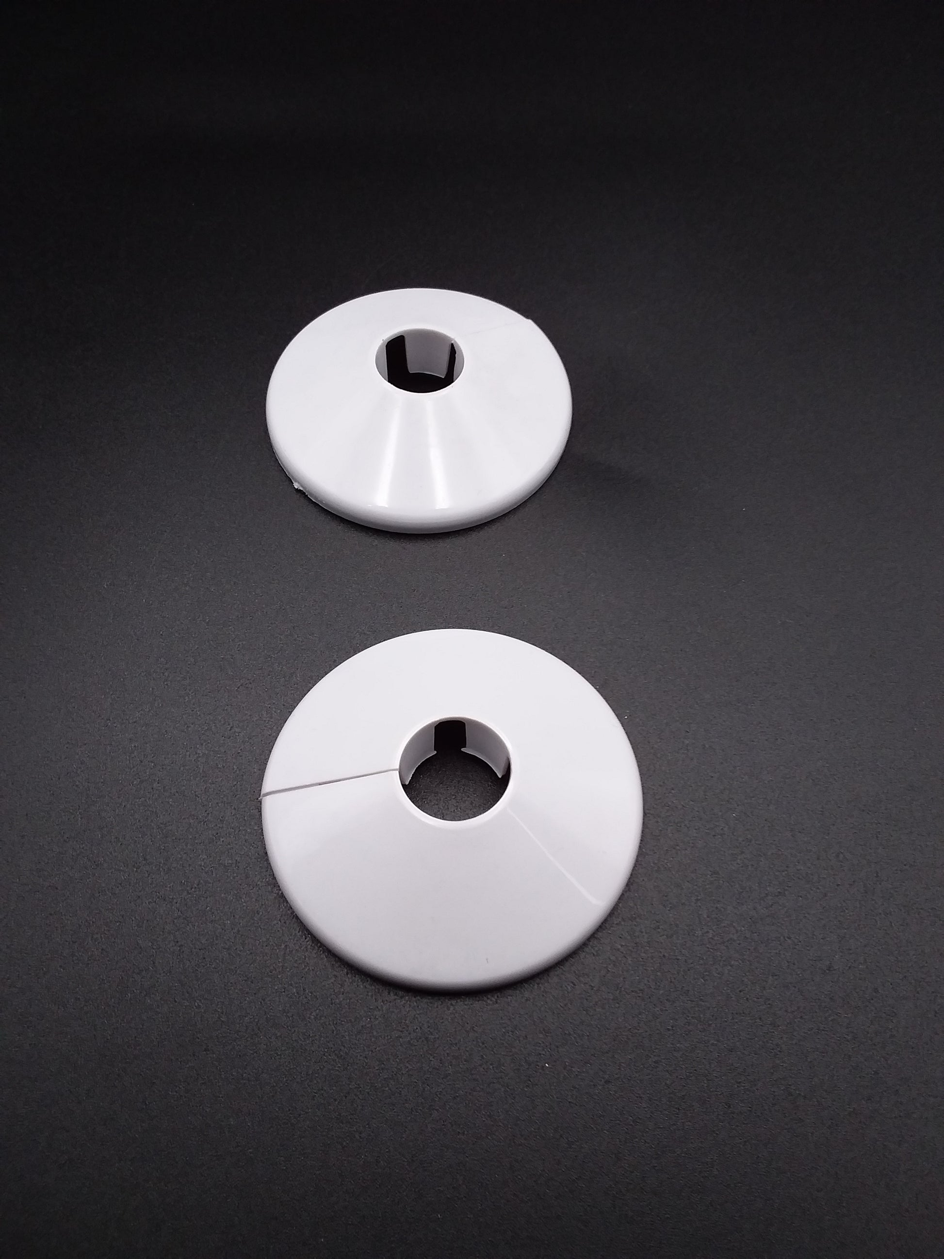 White pipe collars used for plumbing pipe.