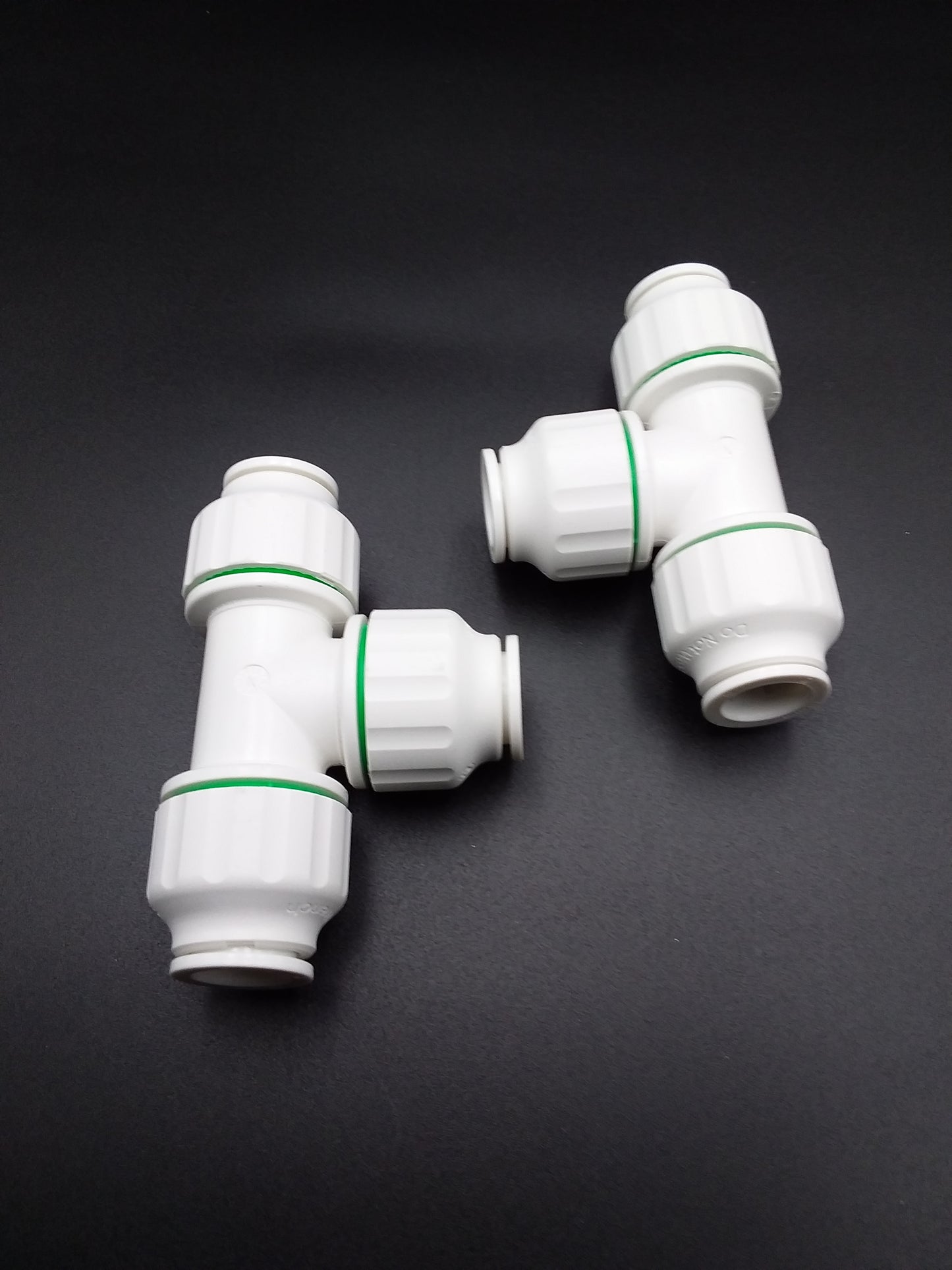 White equal tees with push fit connection points for plumbing.