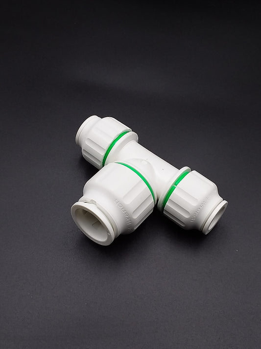 A white push fit reducing tee plumbing fitting with green markings on the connections.