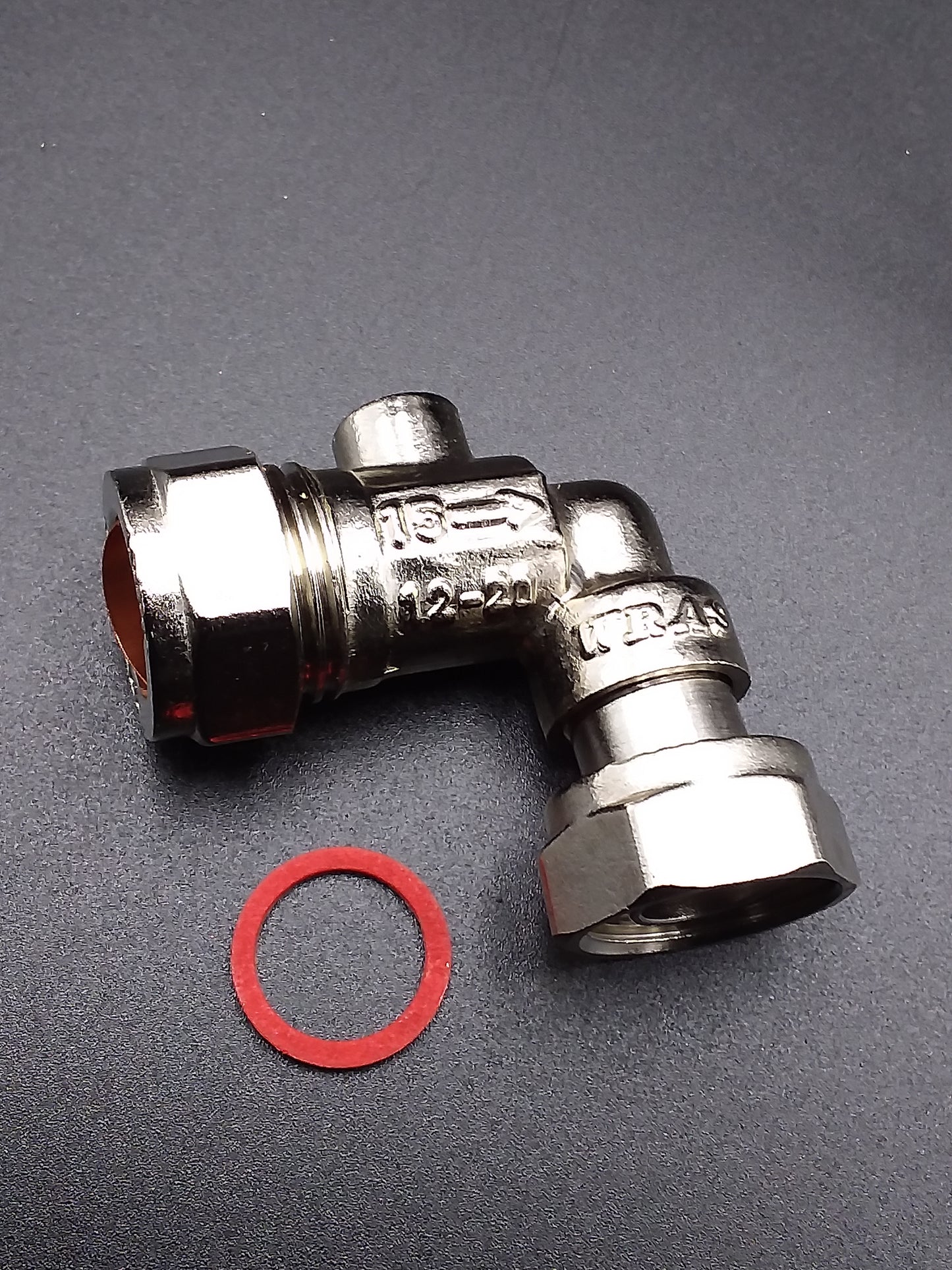 15mm metal service valve with a bent shape and a red circular sealing component next to it, likely for use in plumbing applications.