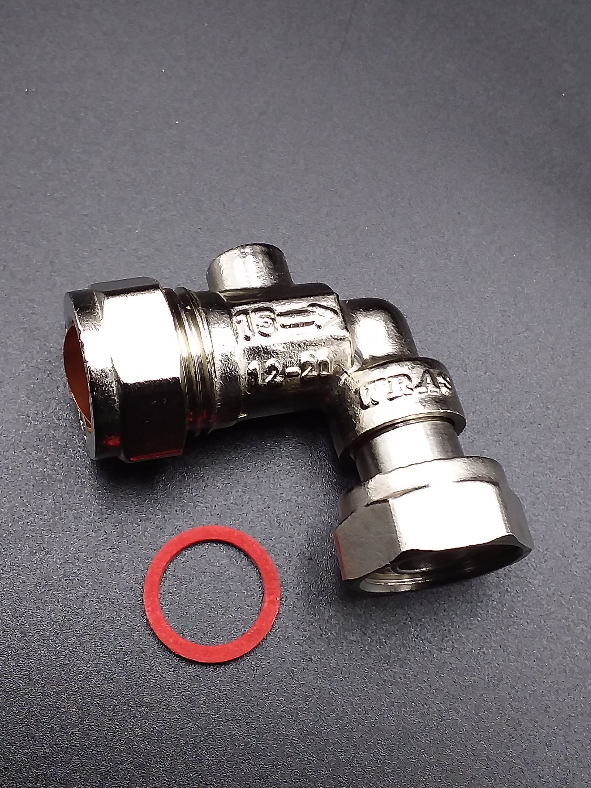 15mm metal service valve with a bent shape and a red circular sealing component next to it, likely for use in plumbing applications.