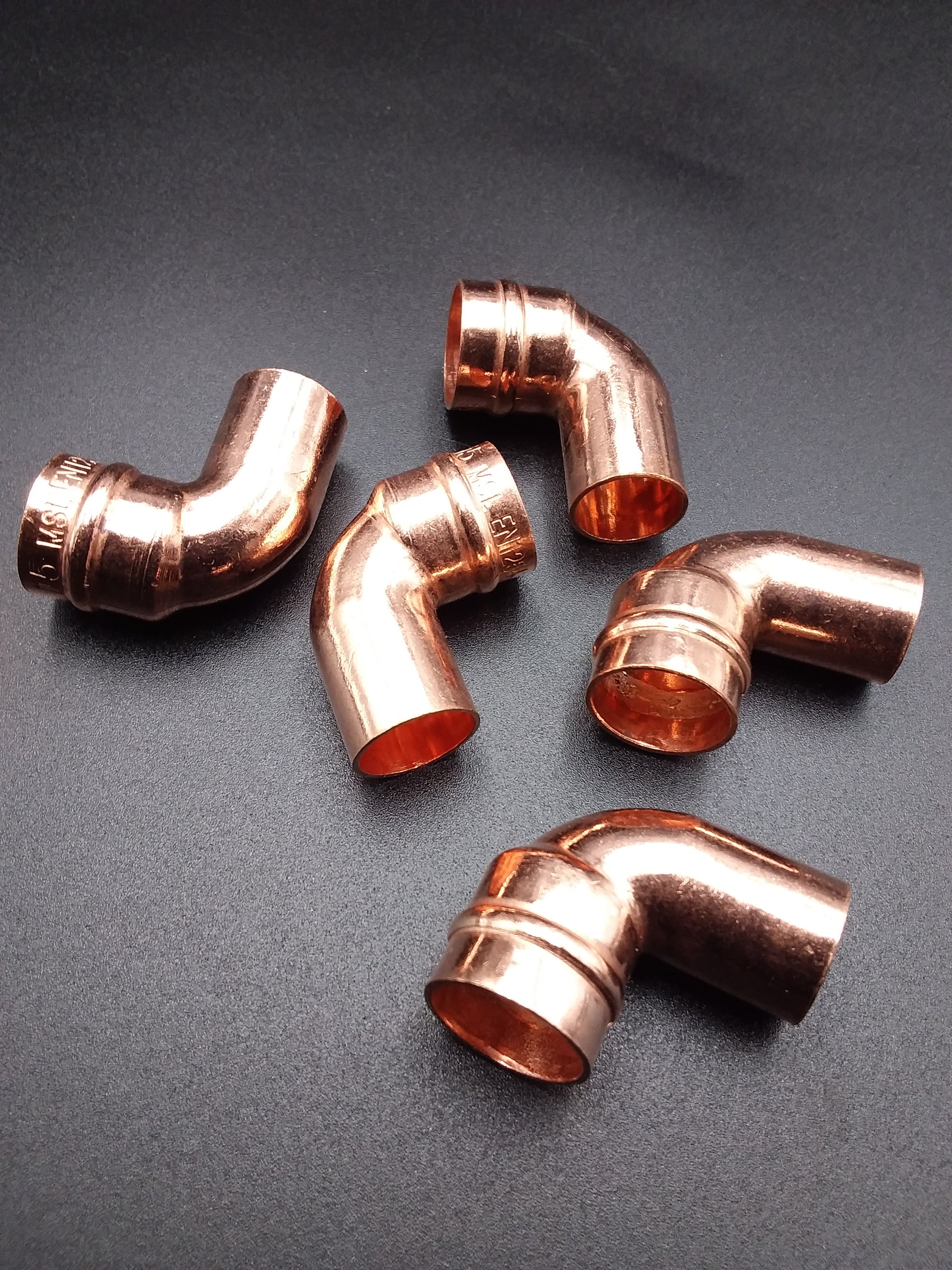 Copper solder ring street elbows, used for plumbing.