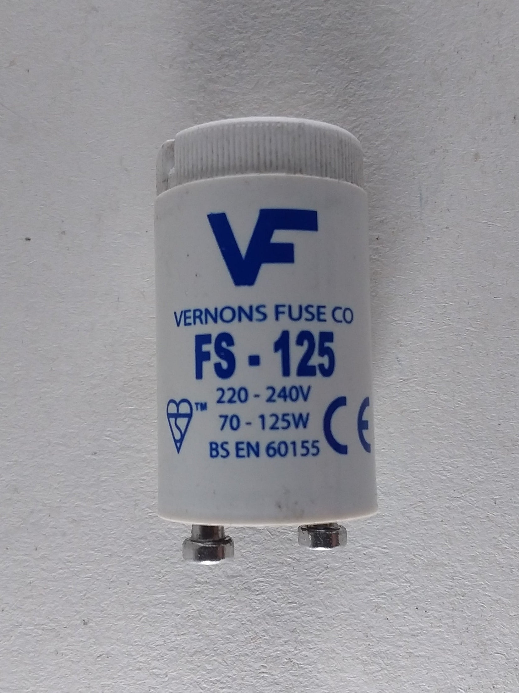 A white lamp starter with the branding 'Vulcan Fluorescent F-125' on it.